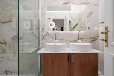 a bathroom with two sinks and a mirror at The Aeolian in Athens