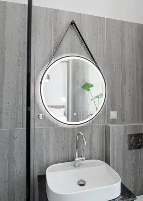 a mirror above a sink in a bathroom at The Aeolian in Athens
