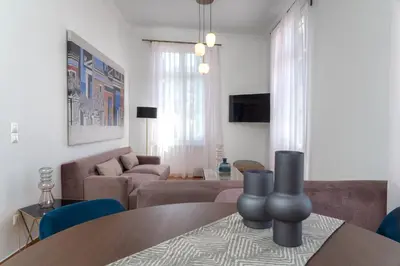 a living room with a table and a couch at The Aeolian in Athens