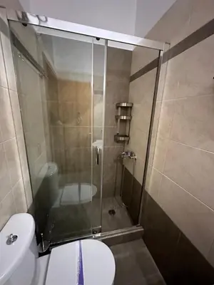 a bathroom with a glass shower with a toilet at Elegant Escapes 5 in Athens