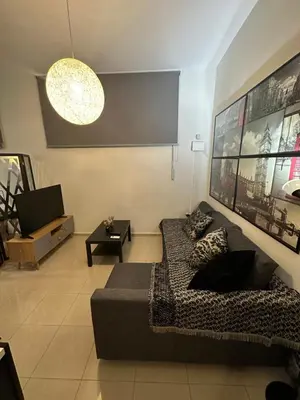 a living room with a couch and a tv at Elegant Escapes 5 in Athens