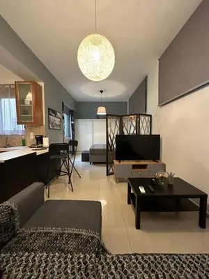 a living room with a couch and a table at Elegant Escapes 5 in Athens