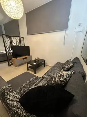 a living room with a bed and a television at Elegant Escapes 5 in Athens