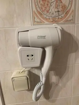 a white phone on a wall in a bathroom at Elegant Escapes 3 in Athens