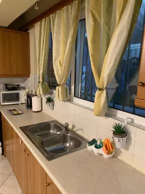 a kitchen counter with a sink and a window at Elegant Escapes 3 in Athens