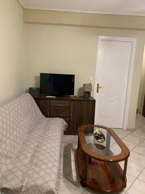 a living room with a couch and a coffee table at Elegant Escapes 3 in Athens