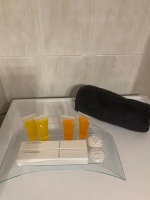 a tray with three glasses of orange juice and a towel at Elegant Escapes 3 in Athens