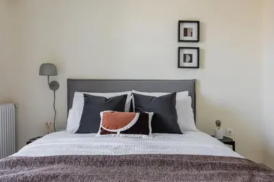 a bedroom with a bed with a pillow on it at Radiant 2BR Apartment in Neo Psichiko by UPSTREET in Athens