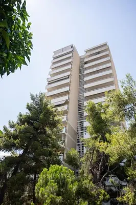 a tall building with trees in front of it at Radiant 2BR Apartment in Neo Psichiko by UPSTREET in Athens