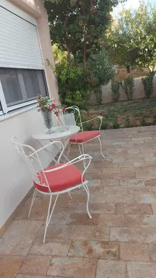 two chairs and a table on a patio at NN Rooms and Suites near Athens Airport in Spáta