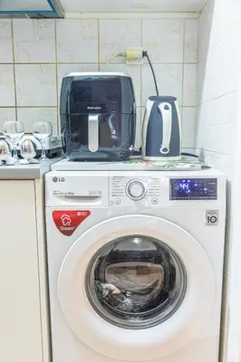 a toaster sitting on top of a washing machine at Unique studio at Athens Riviera 1 min from the sea in Athens