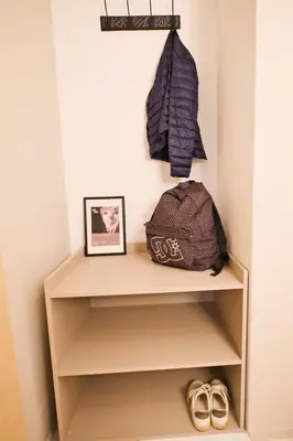 a shelf in a room with a bag and shoes at Unique studio at Athens Riviera 1 min from the sea in Athens