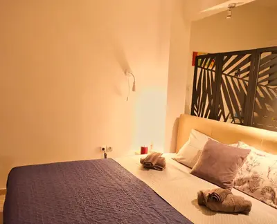 a bedroom with a bed with two towels on it at Unique studio at Athens Riviera 1 min from the sea in Athens