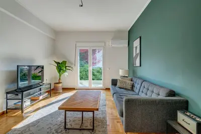 a living room with a couch and a tv at Boutique10 Luxury Apartment in Athens