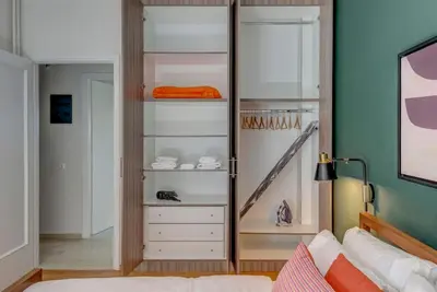 a bedroom with a closet with a dresser and a bed at Boutique10 Luxury Apartment in Athens