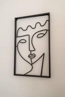 a framed glass picture of a woman on a wall at V.L.A Apartments by the sea in Vari