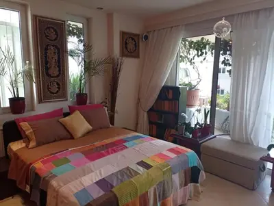 a bedroom with a colorful bed and a large window at Annitas luxury oasis appartment in Athens