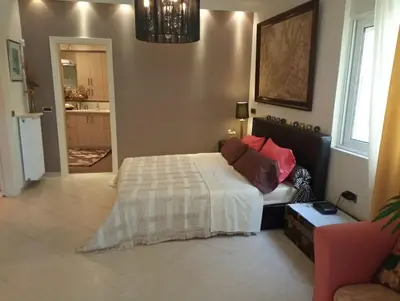 a bedroom with a bed and a living room at Annitas luxury oasis appartment in Athens