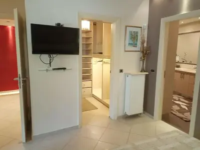 a living room with a flat screen tv on a wall at Annitas luxury oasis appartment in Athens