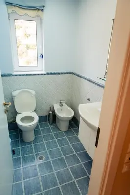 a bathroom with a toilet and a sink at Luxury Cottage Casa con Vista with sea view in Sounio