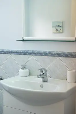 a white sink in a bathroom with a mirror at Luxury Cottage Casa con Vista with sea view in Sounio