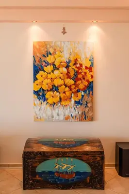 a painting of a boat on a painting on a wall at Luxury Cottage Casa con Vista with sea view in Sounio