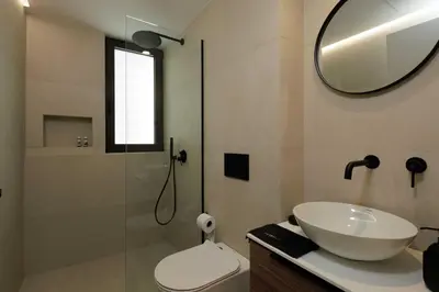 a bathroom with a sink and a toilet and a mirror at Sunshine Suite by Athens Riviera Suites in Saronida