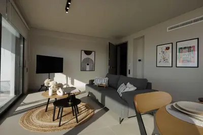 a living room with a couch and a table at Sunshine Suite by Athens Riviera Suites in Saronida