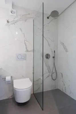 a bathroom with a toilet and a glass shower at Sunshine Suite by Athens Riviera Suites in Saronida