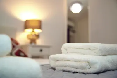 a pile of towels sitting on top of a bed at Superb New Family Apartment VIPGreece in Athens