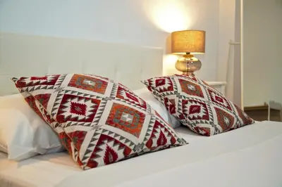 a bed with two pillows and a lamp on it at Superb New Family Apartment VIPGreece in Athens