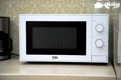 a white microwave sitting on top of a counter at Superb New Family Apartment VIPGreece in Athens