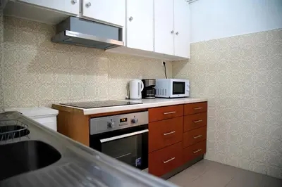 a small kitchen with a sink and a microwave at Superb New Family Apartment VIPGreece in Athens