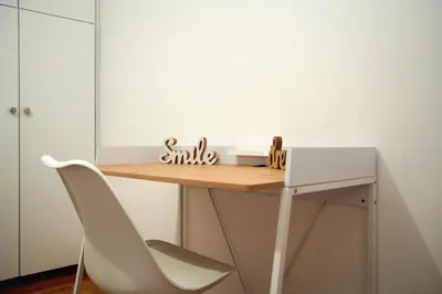a desk in a room with a white chair at Superb New Family Apartment VIPGreece in Athens