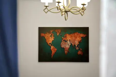a map of the world on a wall with a chandelier at Superb New Family Apartment VIPGreece in Athens