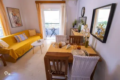 a living room with a table and a yellow couch at Sophia's - Central Apartment Near Egaleo Metro-Athens in Athens