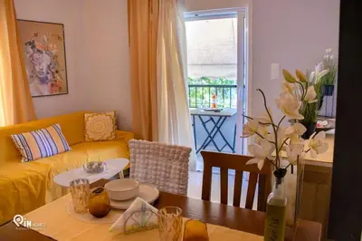 a living room with a yellow couch and a table at Sophia's - Central Apartment Near Egaleo Metro-Athens in Athens
