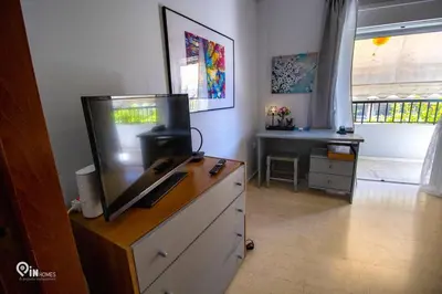 a living room with a tv on top of a dresser at Sophia's - Central Apartment Near Egaleo Metro-Athens in Athens