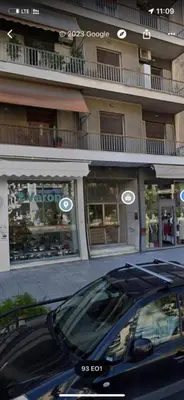 a black car parked in front of a building at Nafousa 1. Nafousa 2 in Athens