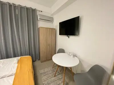 a small room with a bed and a table and a tv at Nafousa 1. Nafousa 2 in Athens
