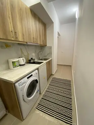a kitchen with a washing machine and a sink at Nafousa 1. Nafousa 2 in Athens