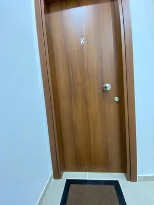 a wooden door in a room with a rug at Nafousa 1. Nafousa 2 in Athens