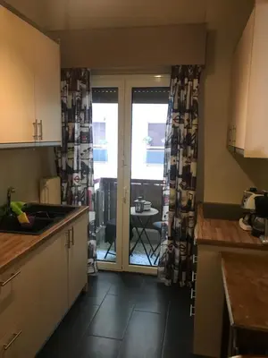 a kitchen with a door open to a patio at Cozy Apartment Downtown in Athens
