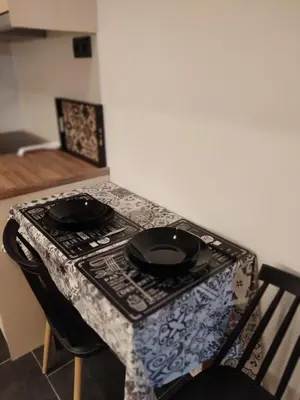 a table with two black plates on top of it at Cozy Apartment Downtown in Athens