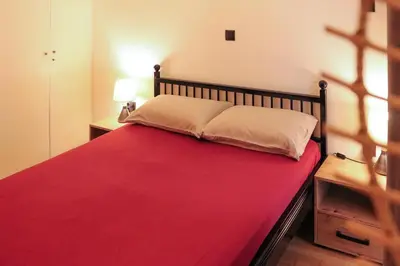 a bedroom with a large bed with a red blanket at Cozy Apartment Downtown in Athens