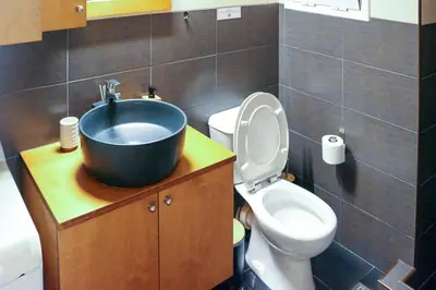 a bathroom with a sink and a toilet at Cozy Apartment Downtown in Athens