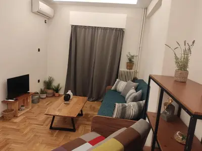 a living room with a couch and a table at Cozy Apartment Downtown in Athens