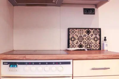 a kitchen with a counter with a stove top oven at Cozy Apartment Downtown in Athens