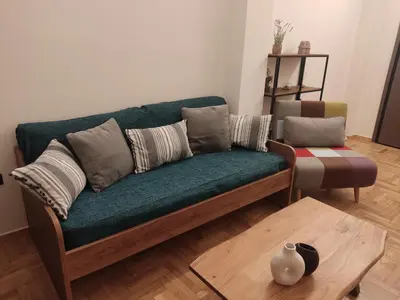 a green couch in a living room with a table at Cozy Apartment Downtown in Athens