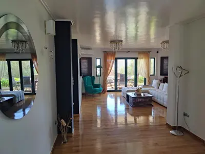 a living room with a couch and a table at John's modern apartments artemida in Artemida